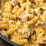Close up of Buffalo Wild Wings garlic parmesan chicken pasta in a skillet.